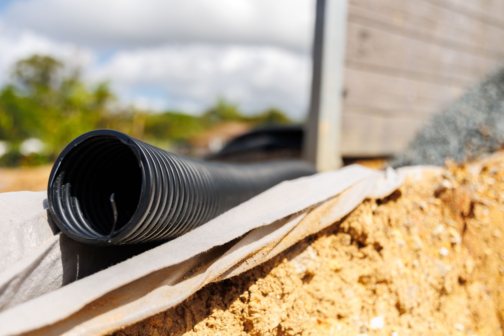 Drainage pipes behind concrete sleeper retaining wall - shallow depth of field